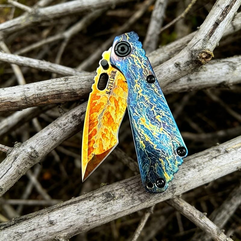 Titanium Burn Pattern Folding Knife Detail on Wood